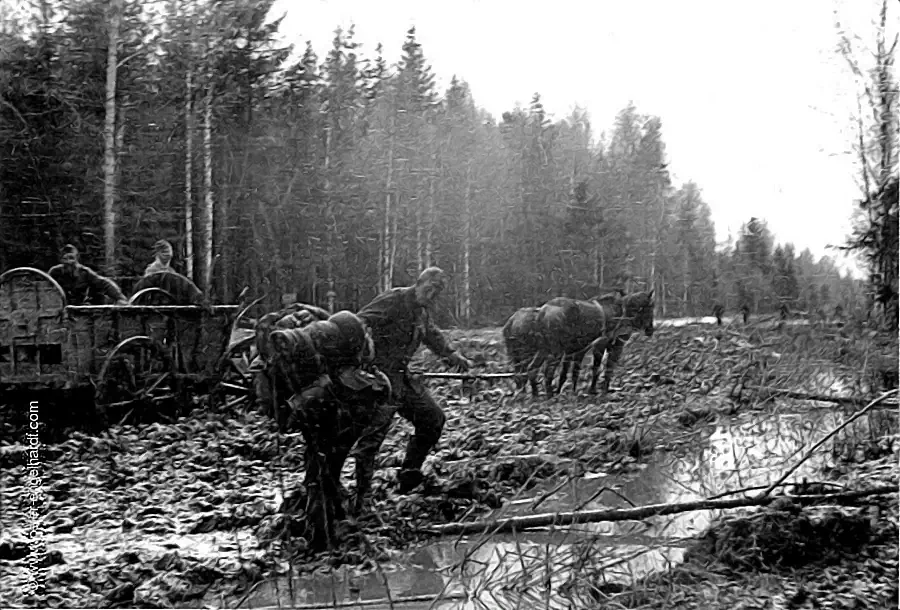 In April 1942, soldiers unload a horse-drawn wagon that had become stuck in the mud on the way to the Volkhov.