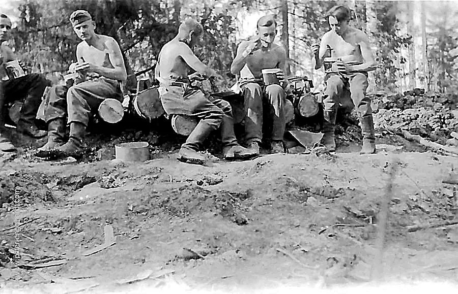 Gruber is eating with four comrades atop the half-finished bunker on the Volkhov; the bunker roof has not yet been covered with earth.